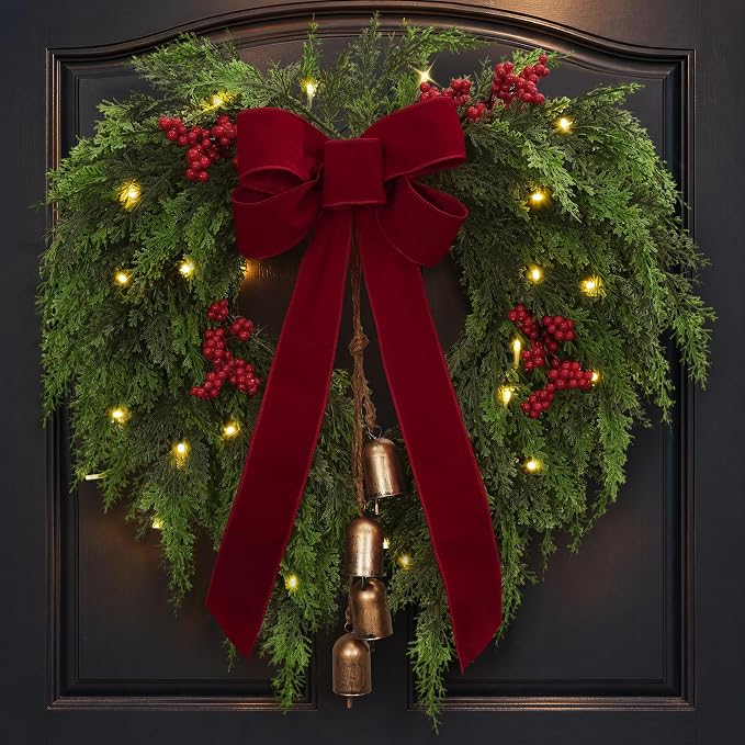 PAPER FAIR 24 Inch Heart Shaped Christmas Wreath for Front Door - Cedar Winter Wreath with Big Red Velvet Bow, 4 Rustic Cowbells, Red Berry Cluster & Battery Operated Lights for Holiday Wall Decor - skull wreath